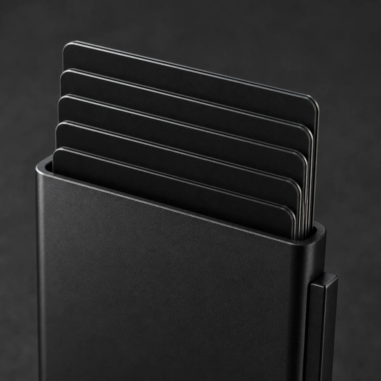 Close-up of NALO Card Holder matte aluminum body and card stack.