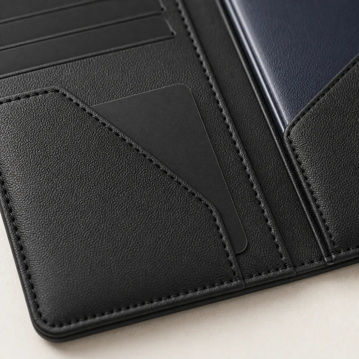 Close-up of NALO Passport Holder leather grain, stitching and card slots.
