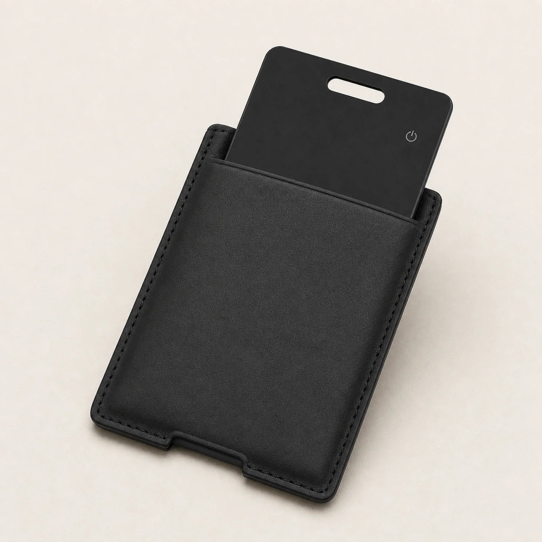 NALO Tracker Card partly inserted into a slim black card holder.