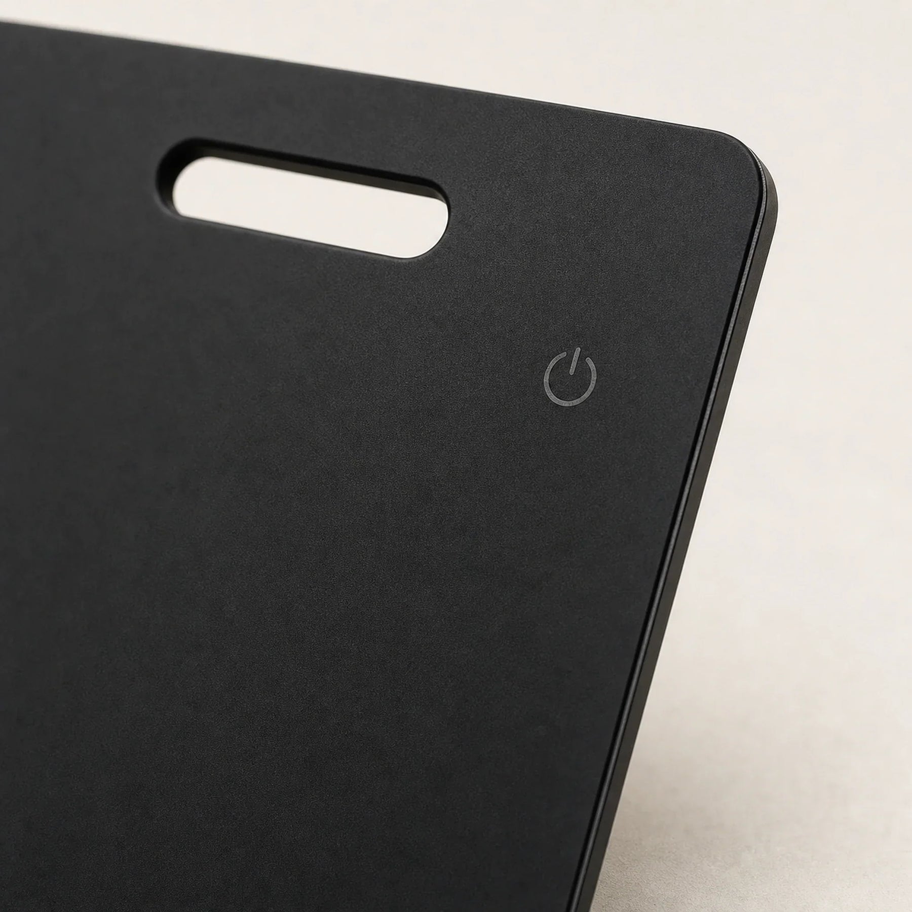 Close-up of the NALO Tracker Card slot, rounded corner, and matte black finish.